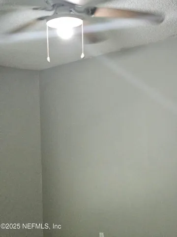 a front view of a house with a garden and trees