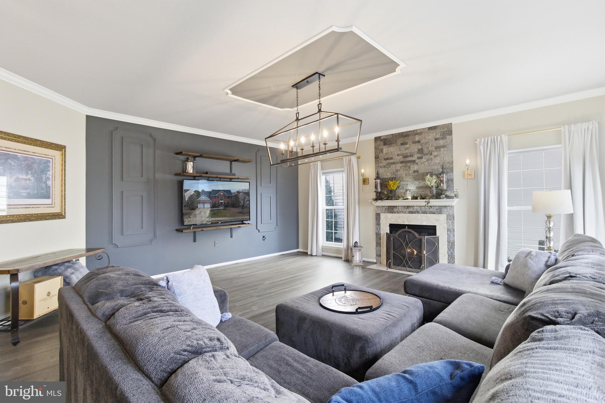 720 Vista Ridge Drive Northeast Leesburg, VA 20176 - Photo 12 of 61 Family room w/ gas fireplace w/wall sconces