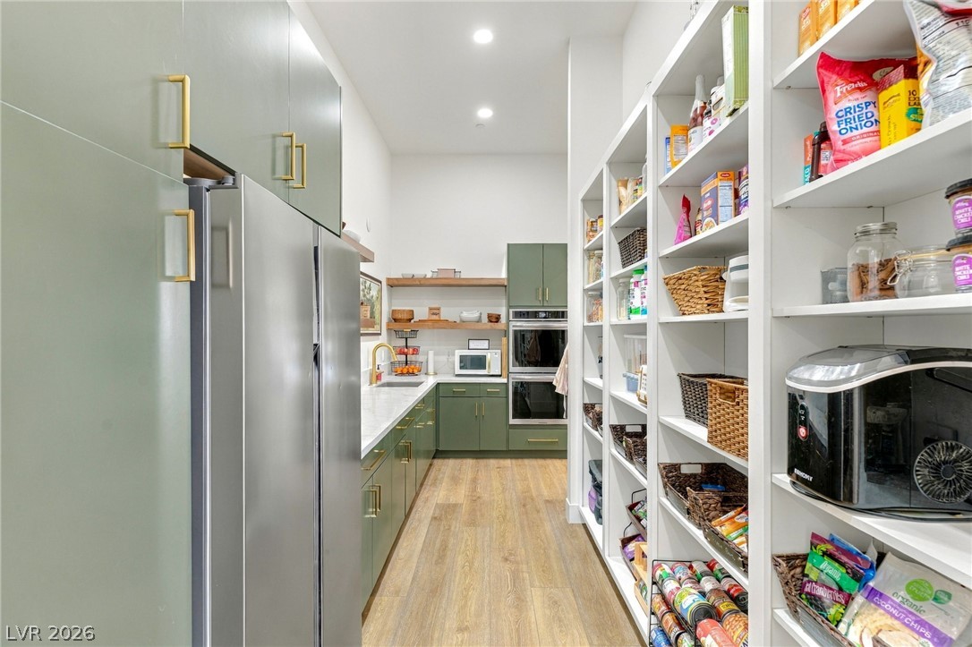 324 Wanda Road Henderson, NV 89002 - Photo 21 of 96 Ample built-in shelving pairs with sleek modern cabinetry and durable wood flooring.