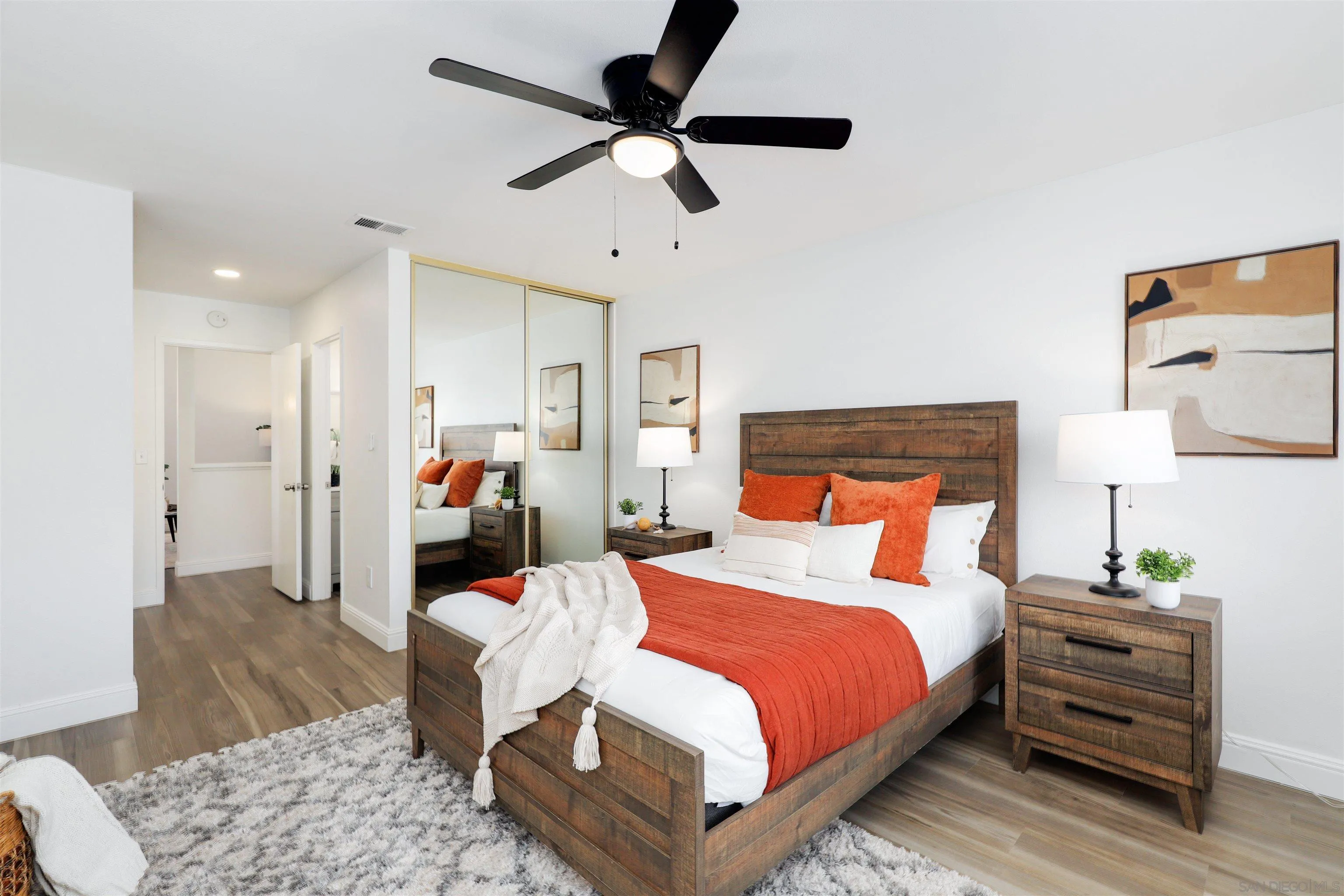 3933 Brown Street Oceanside, CA 92056 - Photo 15 of 25 a bedroom with a bed and wooden floor