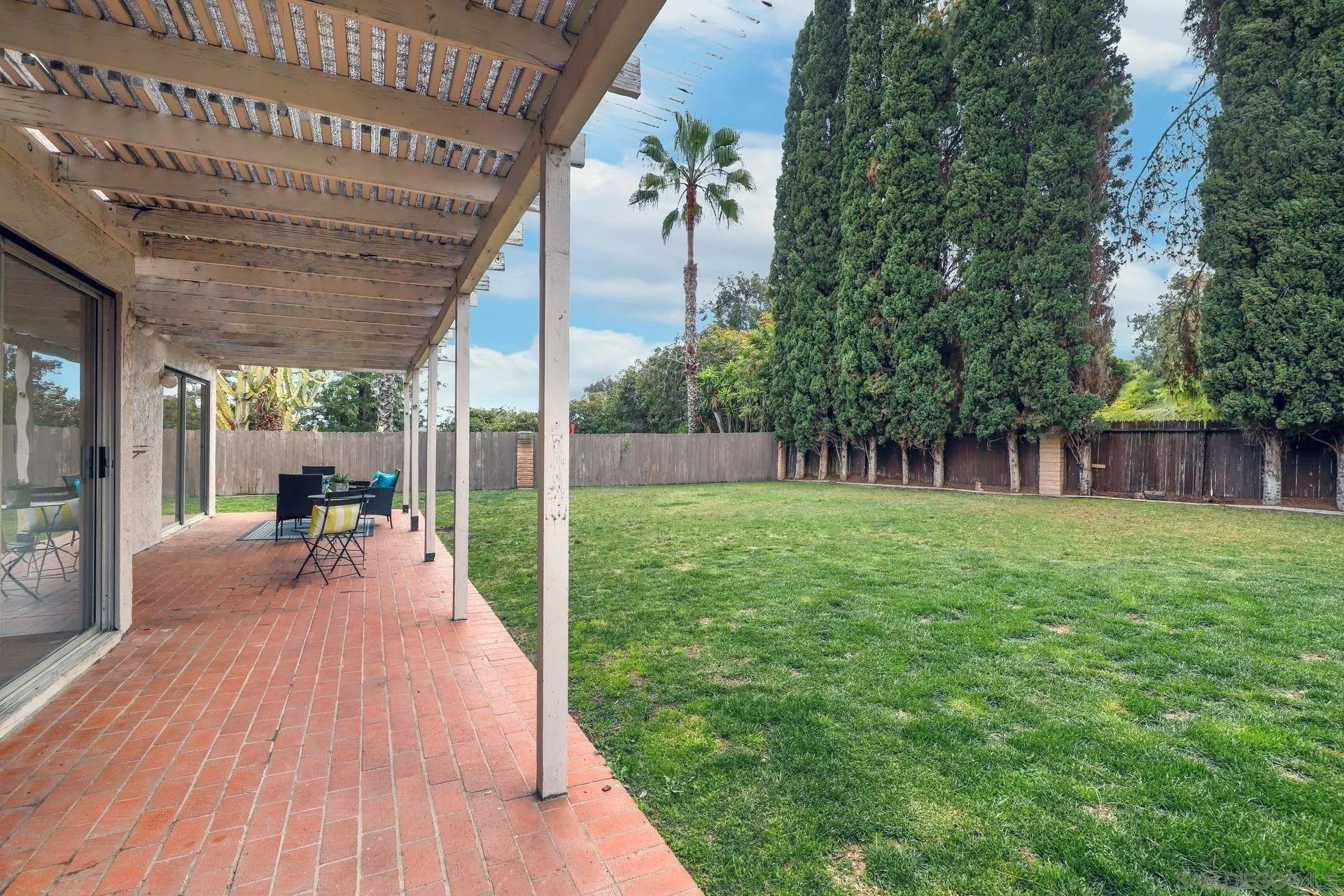 3933 Brown Street Oceanside, CA 92056 - Photo 21 of 25 a view of a backyard with couches plants and large tree