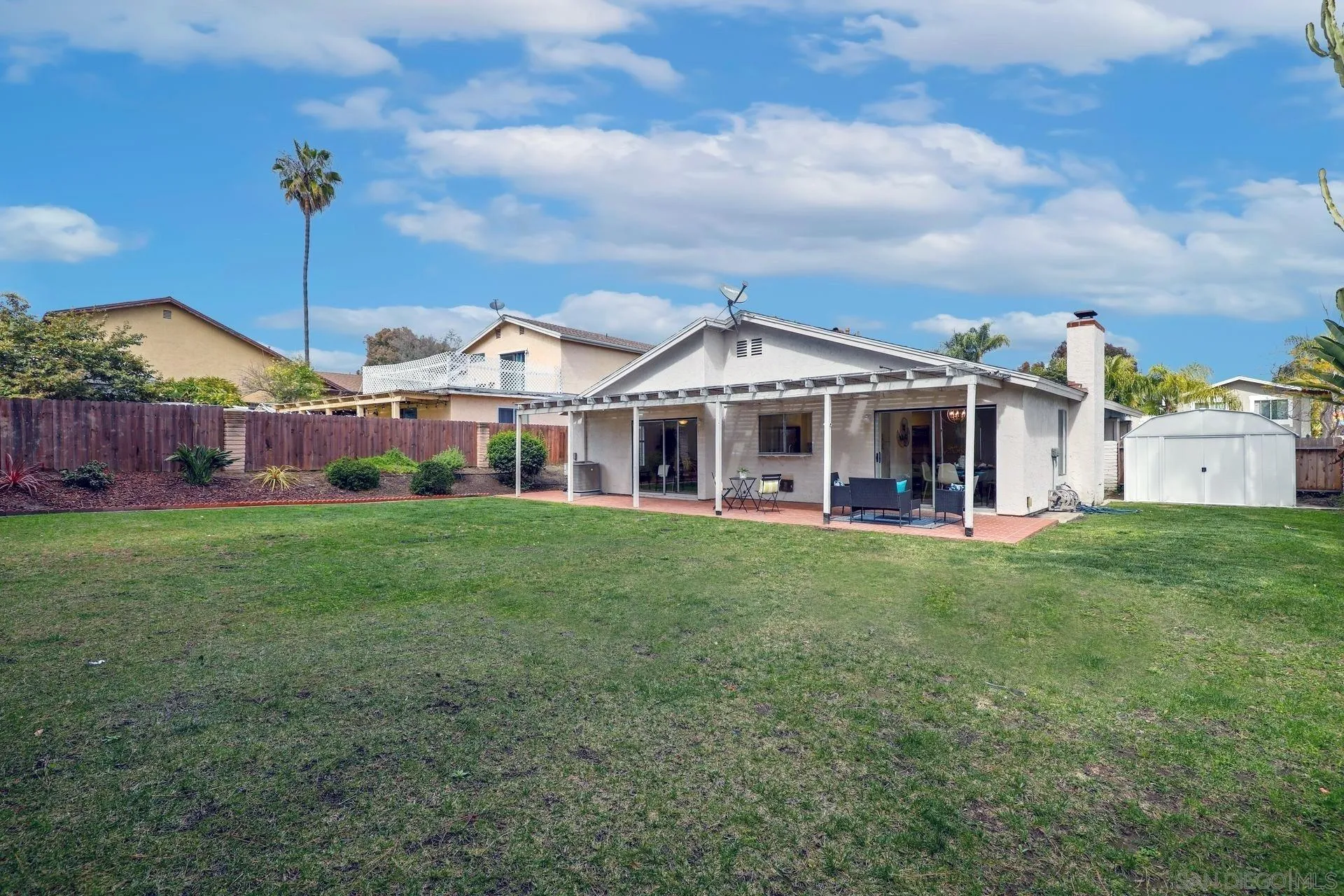 3933 Brown Street Oceanside, CA 92056 - Photo 24 of 25 a view of a house with a big yard and large trees