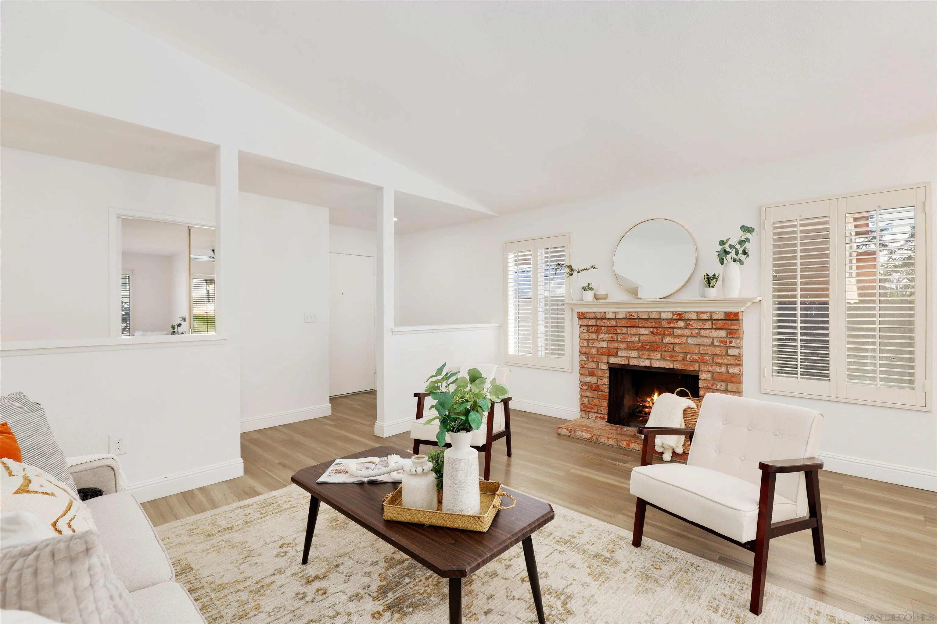 3933 Brown Street Oceanside, CA 92056 - Photo 3 of 25 a living room with furniture and a fireplace