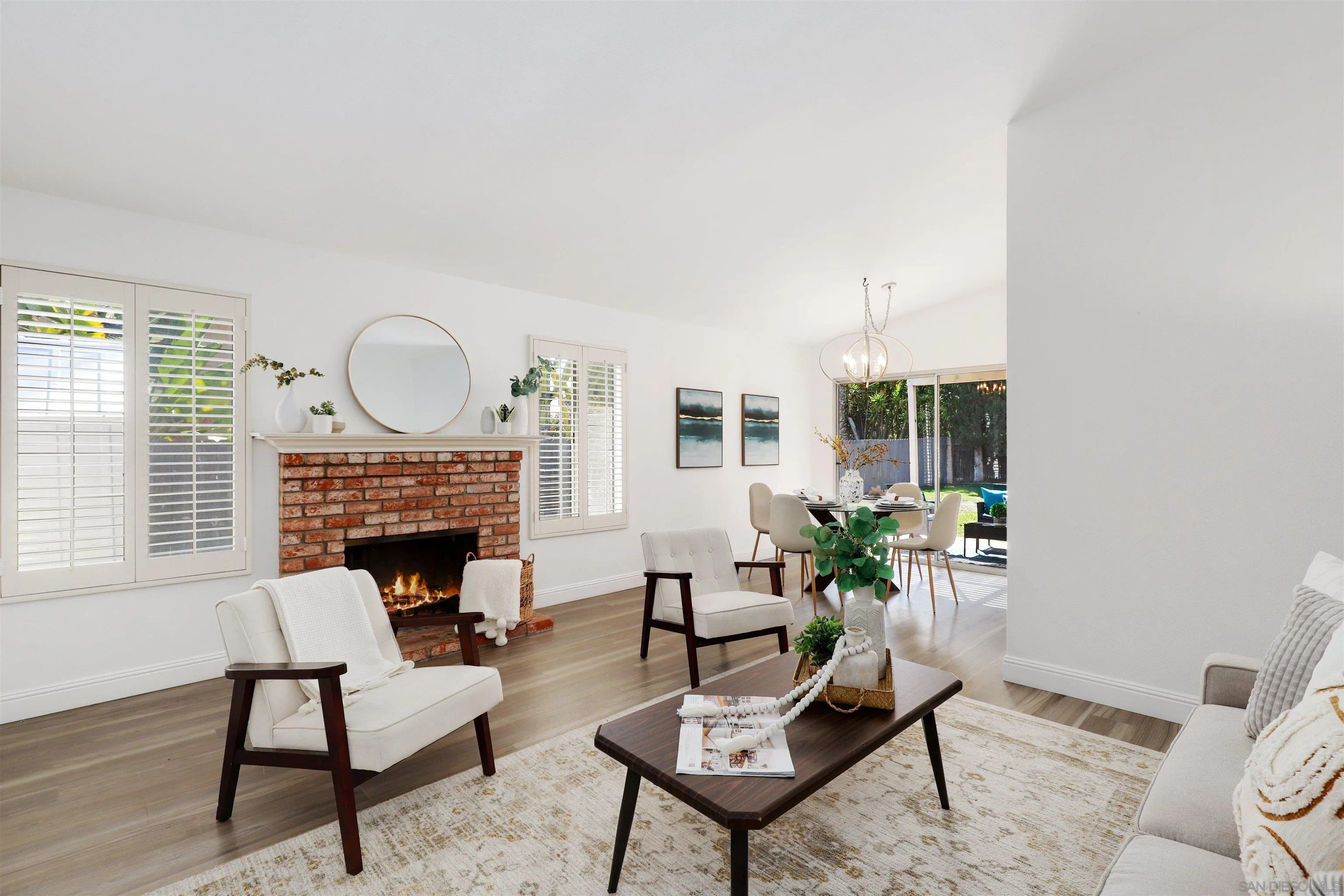 3933 Brown Street Oceanside, CA 92056 - Photo 4 of 25 a living room with furniture a fireplace and a potted plant