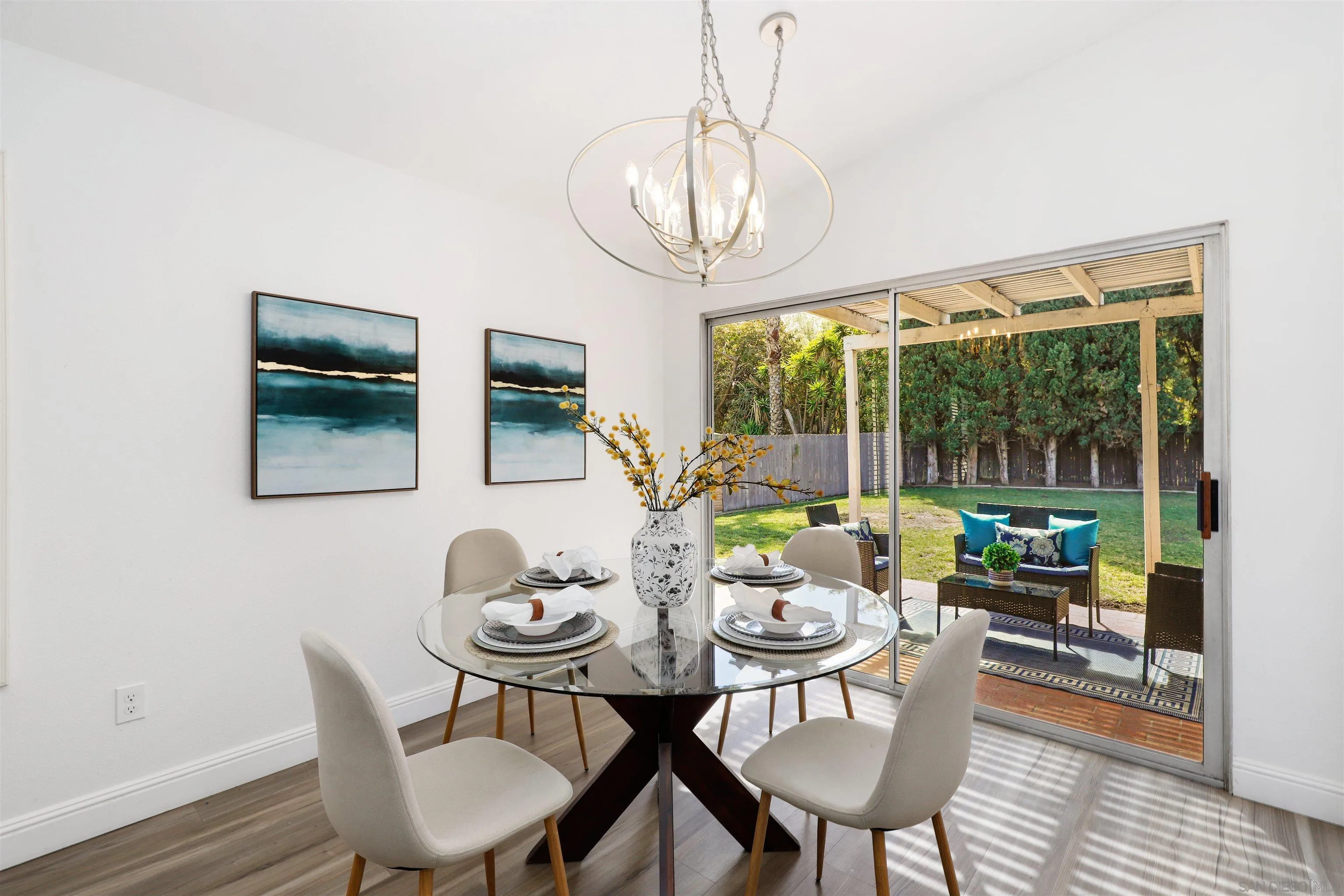 3933 Brown Street Oceanside, CA 92056 - Photo 5 of 25 a view of a dining room with furniture wooden floor and a chandelier