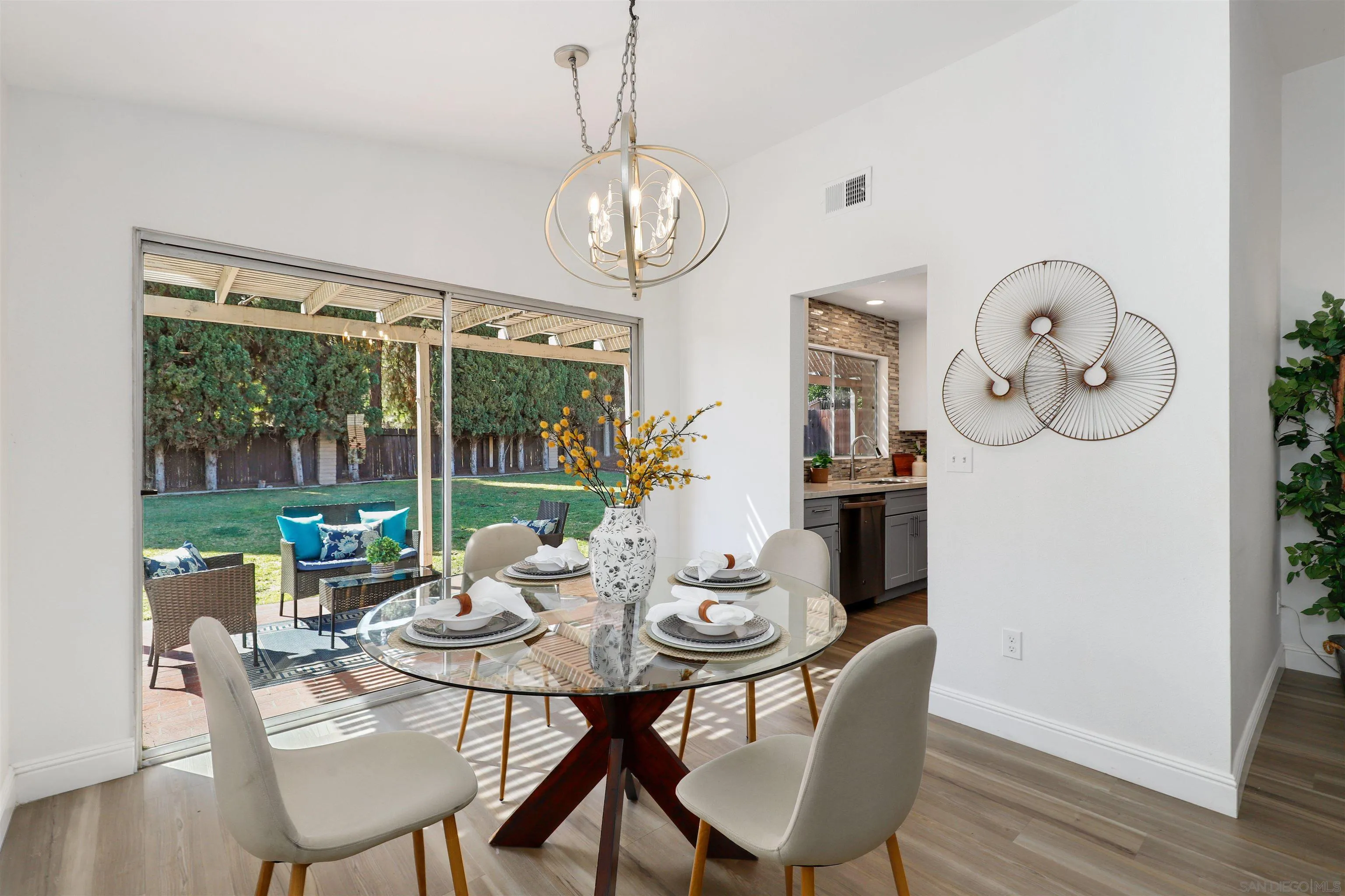 3933 Brown Street Oceanside, CA 92056 - Photo 6 of 25 a view of a dining room with furniture wooden floor and chandelier