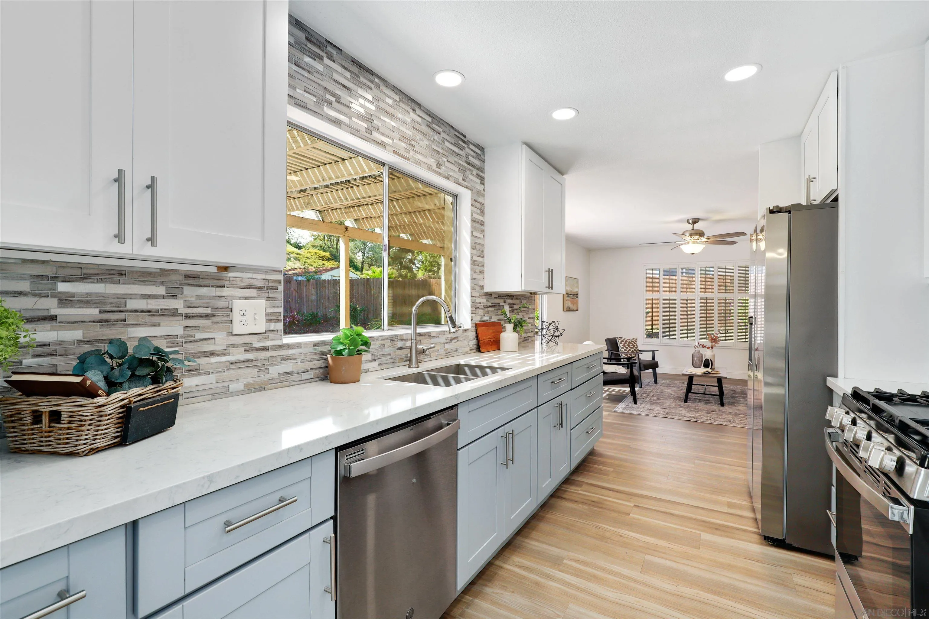 3933 Brown Street Oceanside, CA 92056 - Photo 7 of 25 a kitchen with sink a counter top space and living room area