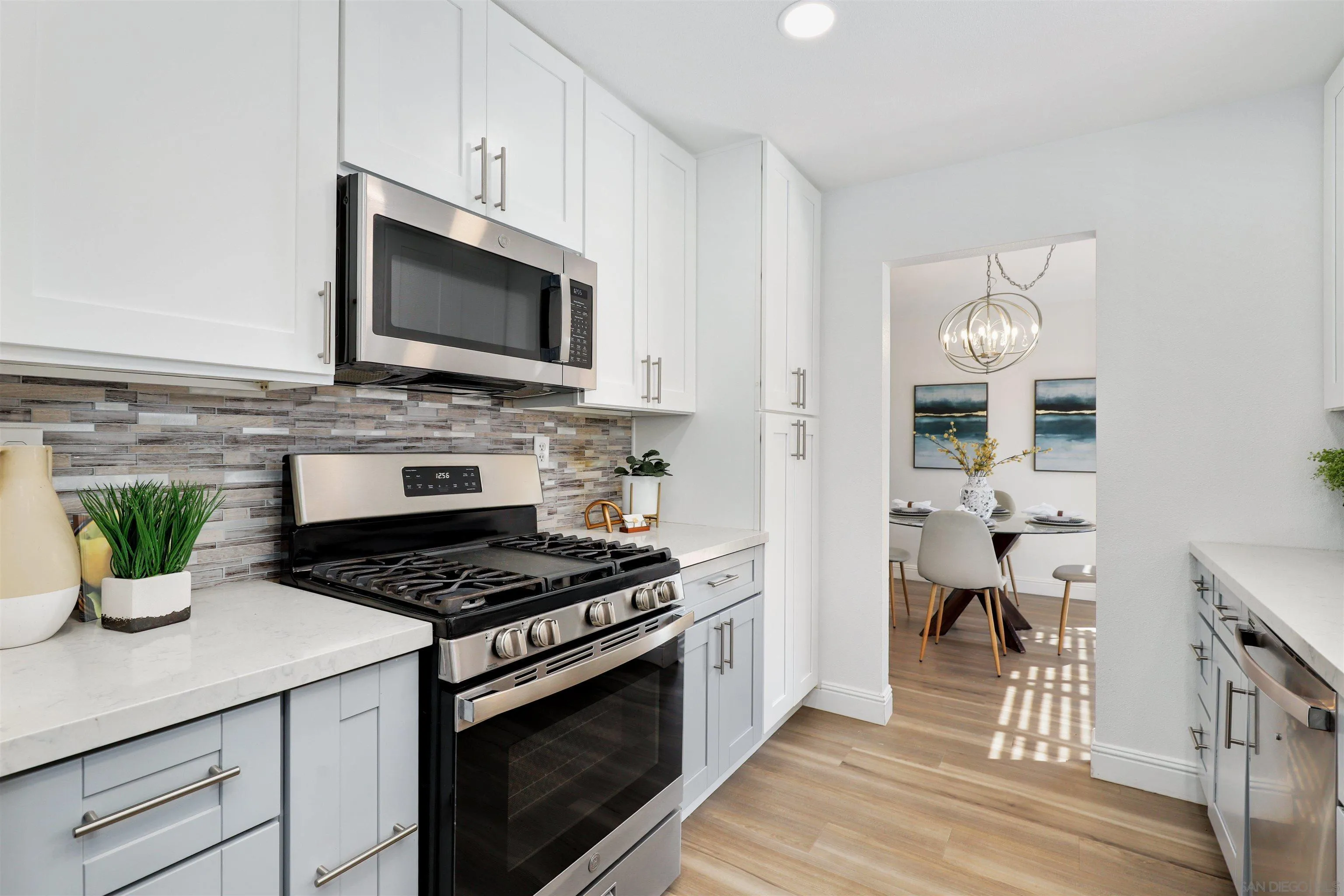 3933 Brown Street Oceanside, CA 92056 - Photo 9 of 25 a kitchen with a stove and a microwave