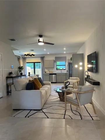 a living room with couches and a flat screen tv