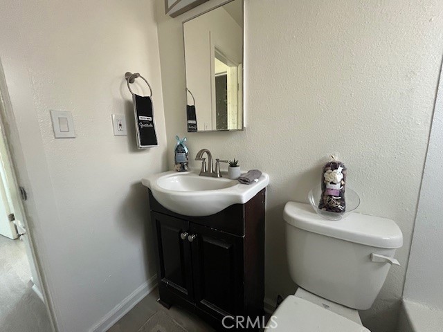 37067 Bankside Drive, Unit B Cathedral City, CA 92234 - Photo 16 of 23 a bathroom with a toilet sink and mirror