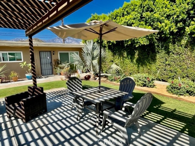 37067 Bankside Drive, Unit B Cathedral City, CA 92234 - Photo 19 of 23 a view of a patio with a table chairs and a potted plant