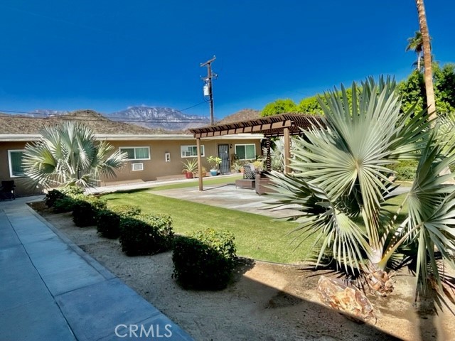 37067 Bankside Drive, Unit B Cathedral City, CA 92234 - Photo 3 of 23 a view of a swimming pool with lawn chairs under an umbrella