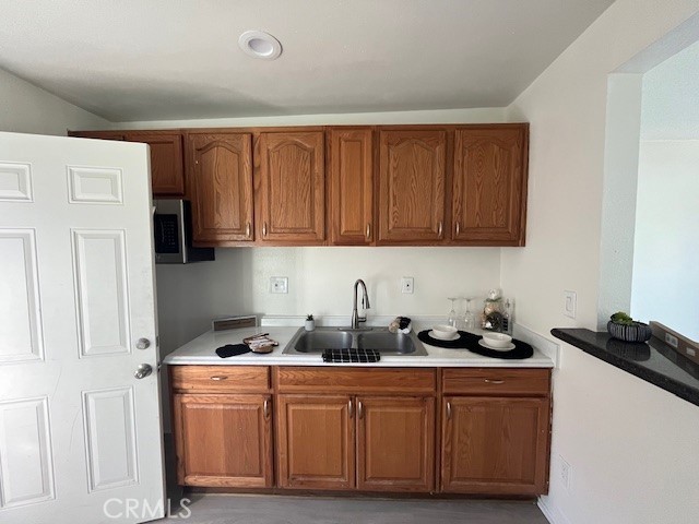 37067 Bankside Drive, Unit B Cathedral City, CA 92234 - Photo 9 of 23 a kitchen with stainless steel appliances granite countertop a refrigerator sink and cabinets