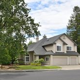 a front view of a house with a garden and yard