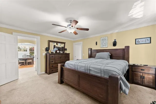 a large white kitchen with wooden floors and stainless steel appliances