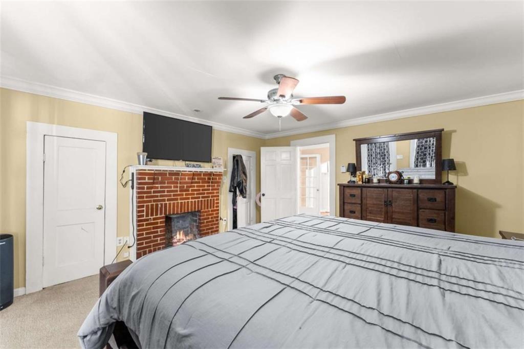 6622 Old Cleveland Road Clermont, GA 30527 - Photo 22 of 69 a spacious bedroom with a large bed a flat tv screen and a dresser