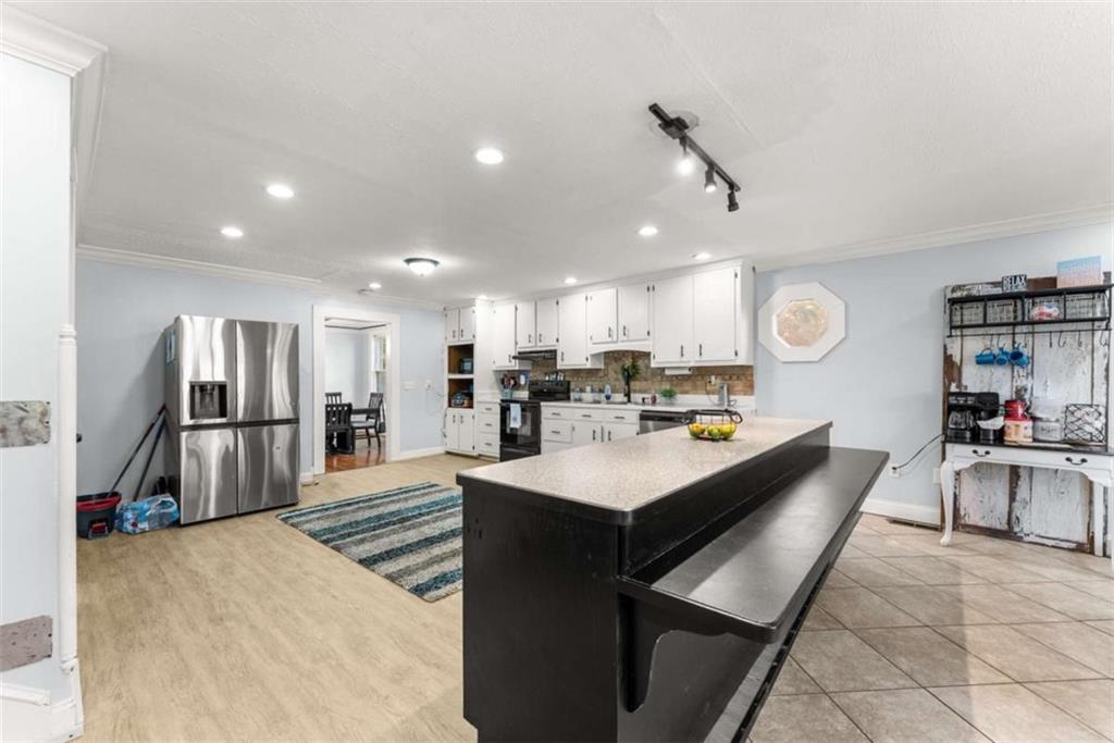 6622 Old Cleveland Road Clermont, GA 30527 - Photo 25 of 69 a large kitchen with a center island appliances and a counter top space