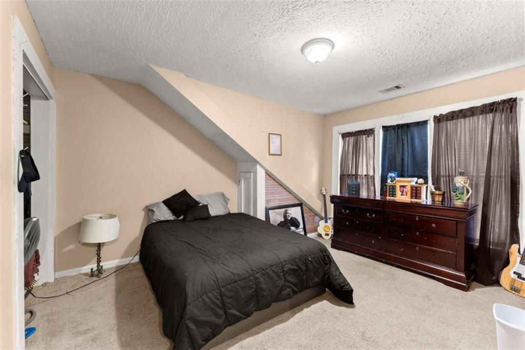 6622 Old Cleveland Road Clermont, GA 30527 - Photo 35 of 69 a bedroom with a bed and a dresser