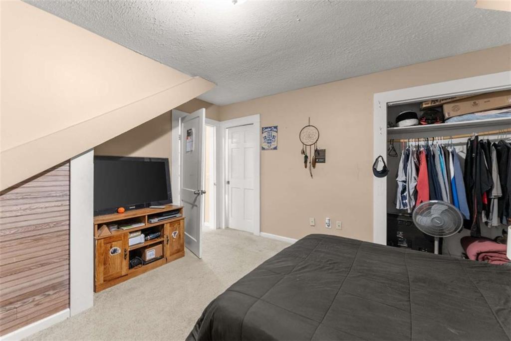 6622 Old Cleveland Road Clermont, GA 30527 - Photo 36 of 69 a bedroom with a bed and a flat screen tv