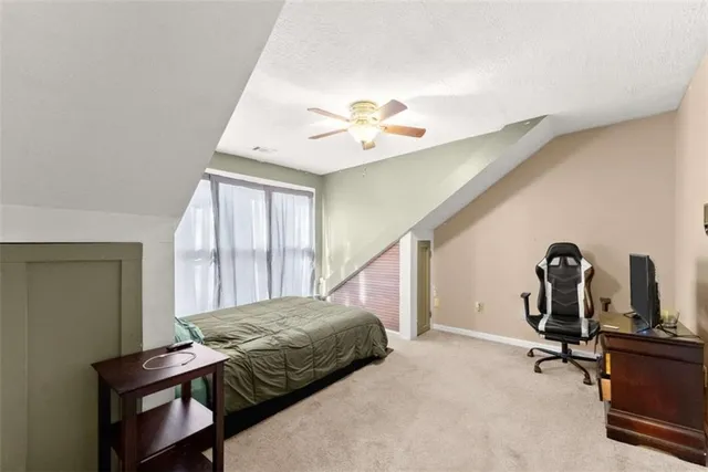 a view of a house with a yard and sitting area