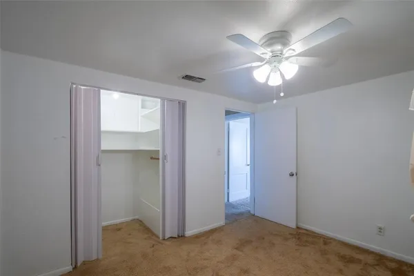 a view of a chandelier fan and closet in a room