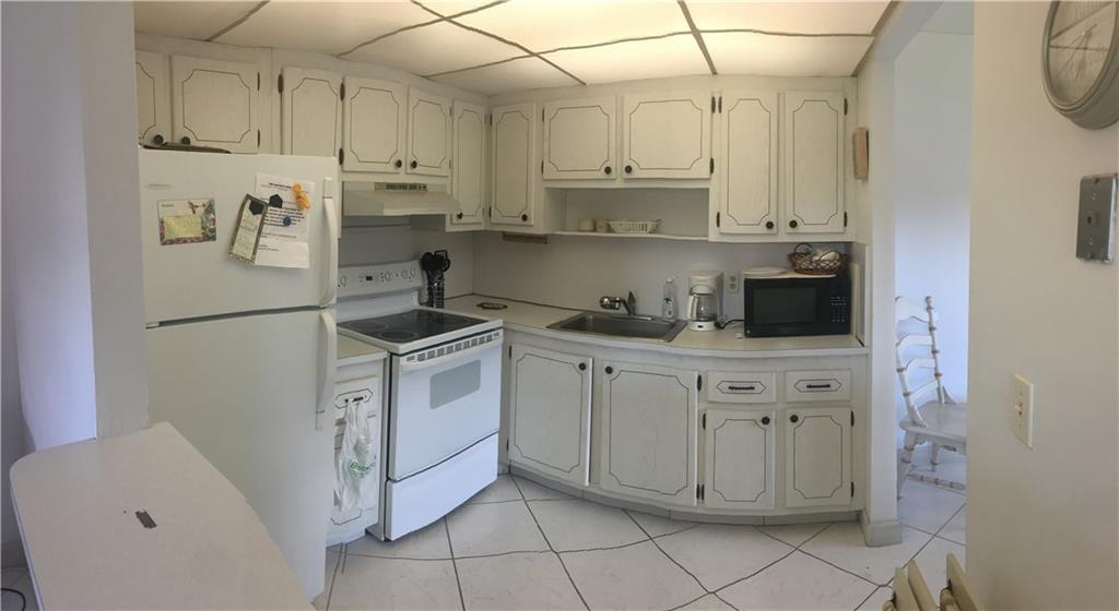 Kings Point Delray Beach, FL 33446 - Photo 4 of 7 a kitchen with cabinets and appliances