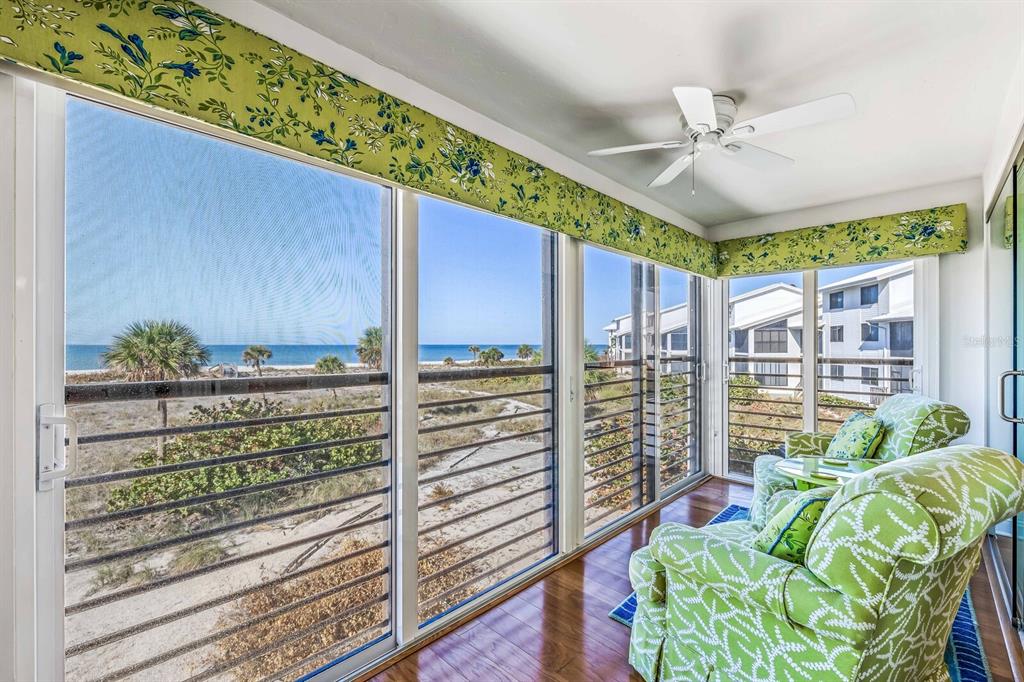 5000 Gasparilla Road, Unit BC204 Boca Grande, FL 33921 - Photo 11 of 36 a view of a porch with furniture and a floor to ceiling window