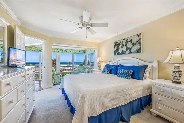 a large white bedroom with a large bed and a window