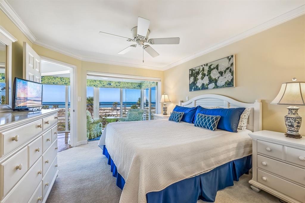 5000 Gasparilla Road, Unit BC204 Boca Grande, FL 33921 - Photo 12 of 36 a large white bedroom with a large bed and a window
