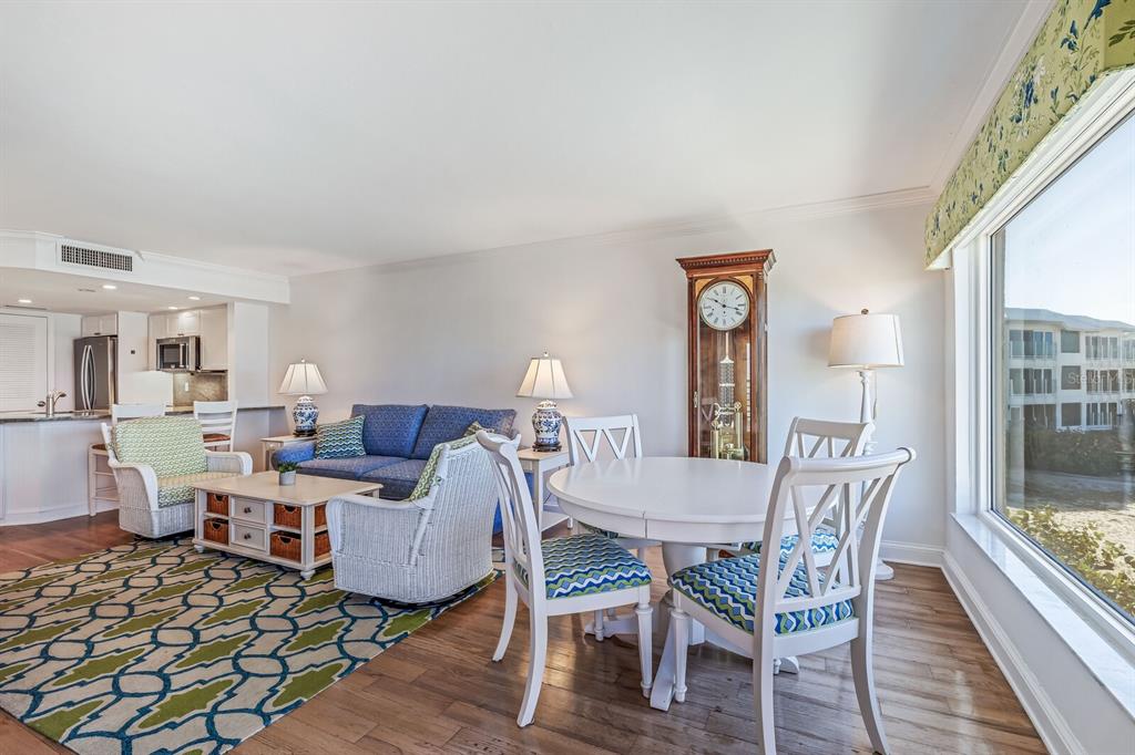 5000 Gasparilla Road, Unit BC204 Boca Grande, FL 33921 - Photo 8 of 36 a view of a dining room with furniture window and wooden floor