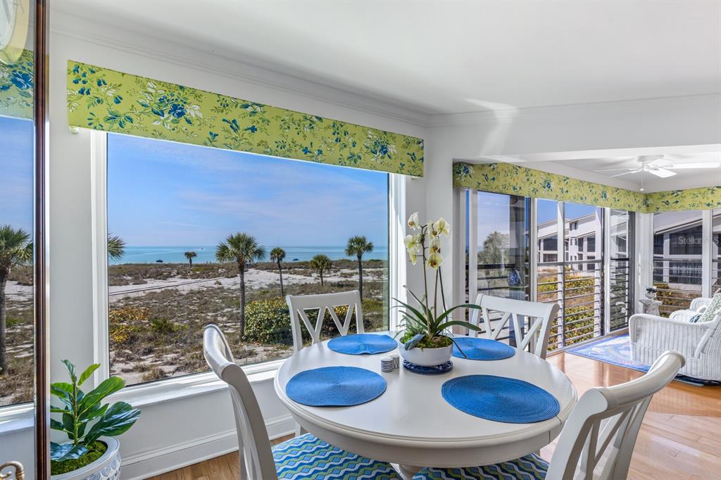 5000 Gasparilla Road, Unit BC204 Boca Grande, FL 33921 - Photo 10 of 36 a view of a dining room with furniture one side kitchen view and wooden floor