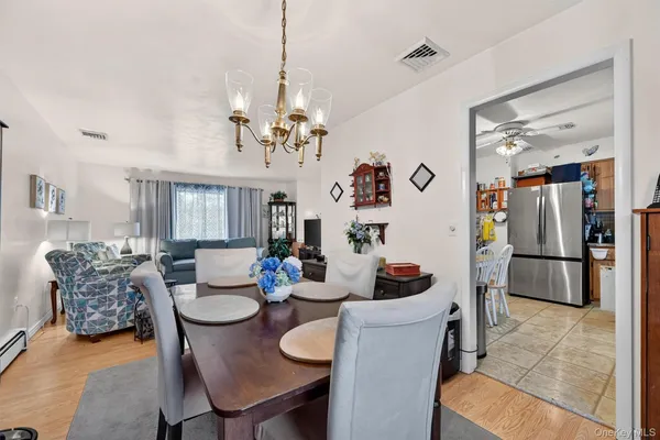 a dining room with furniture and chandelier