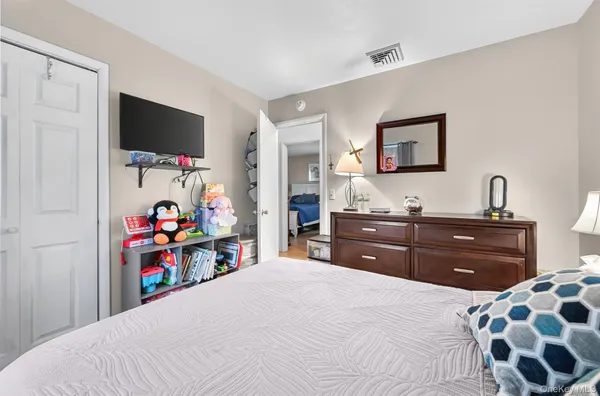 a bedroom with a bed and a flat screen tv