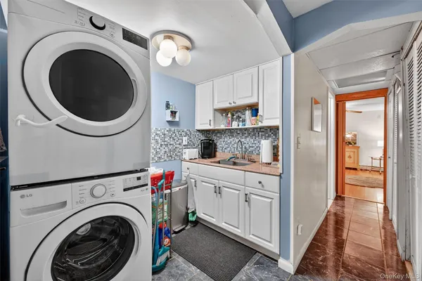 a view of a hallway with washer and dryer