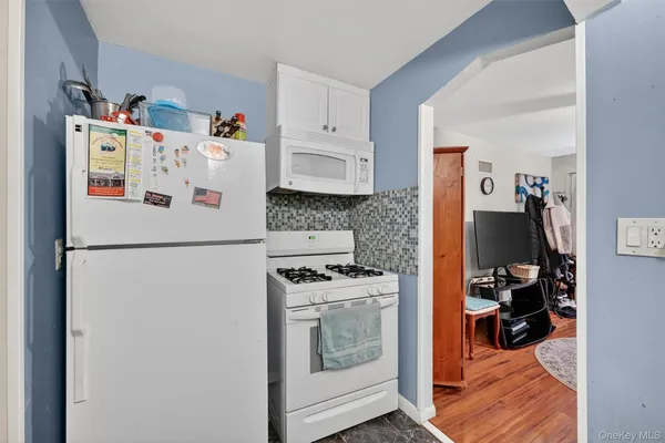 a white refrigerator freezer sitting inside of a kitchen