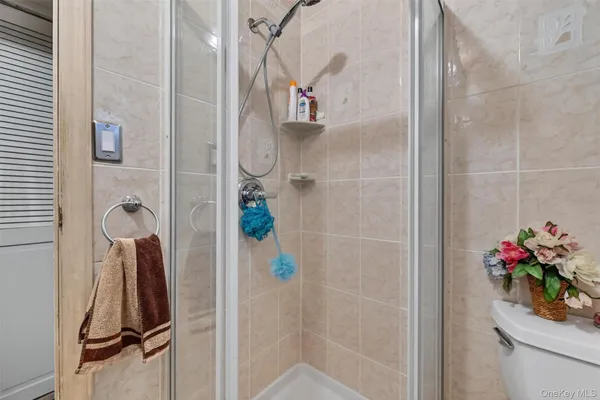 a bathroom with a shower and a mirror