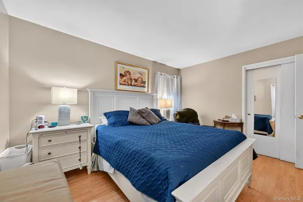 a bedroom with a large bed and a dresser
