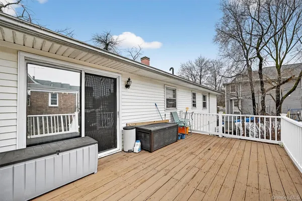 a view of a deck with wooden floor and fence
