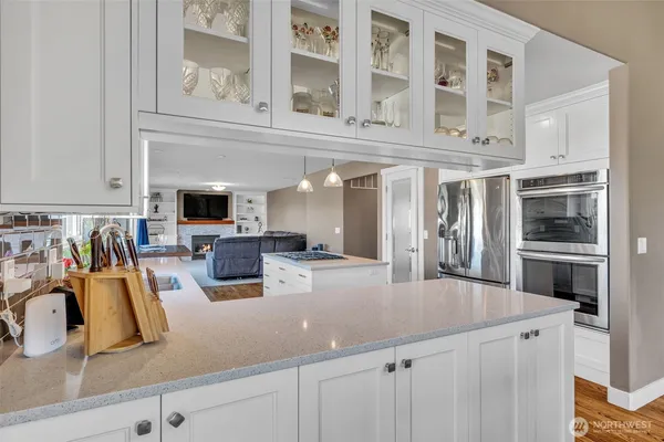 a kitchen with stainless steel appliances granite countertop a sink dishwasher stove and refrigerator