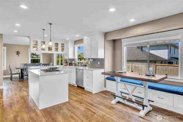 a kitchen with a sink cabinets and wooden floor