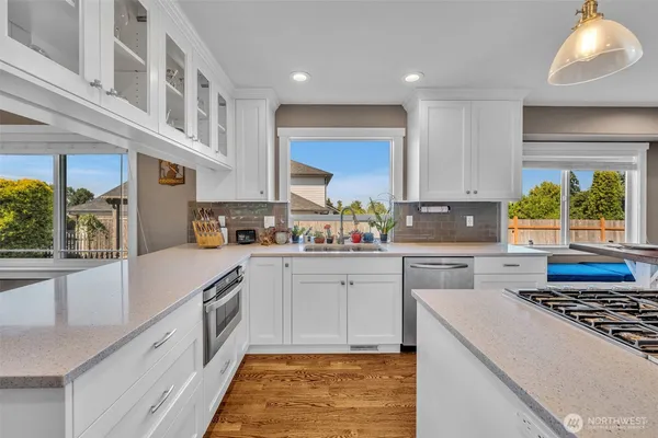 a kitchen with stainless steel appliances granite countertop a stove a sink and a refrigerator