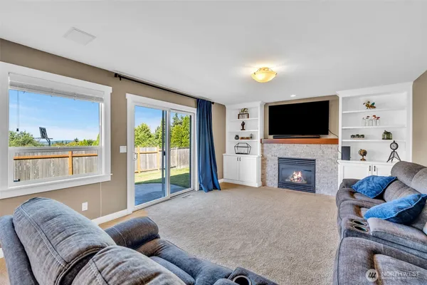 a living room with furniture a fireplace and a flat screen tv