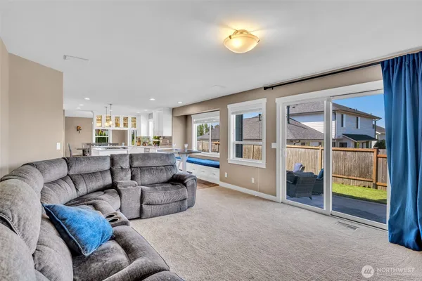 a living room with furniture and a floor to ceiling window