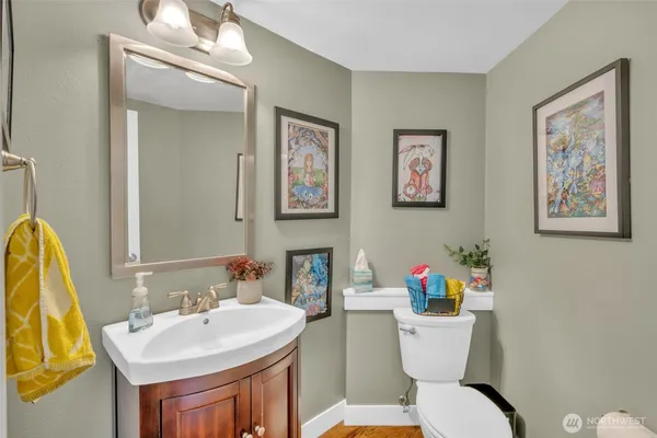 a bathroom with a toilet a sink and a mirror