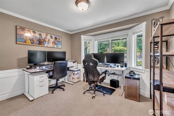 a view of a livingroom with workspace and a window