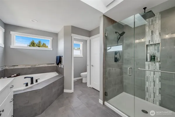 a bathroom with a bathtub and a shower
