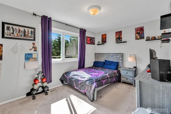 a bedroom with a bed and a tv