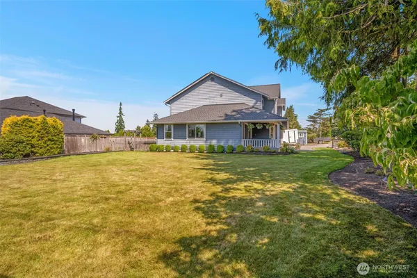 a aerial view of a house with swimming pool and large trees