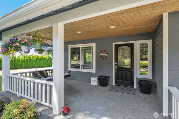 a porch with a table and chairs in patio