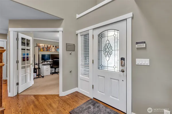 a view of a livingroom with wooden floor and a window